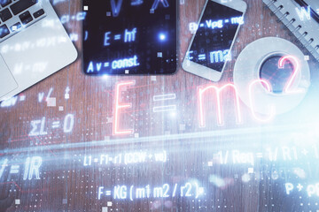 Double exposure of formula drawing over table with phone. Top view. Education concept.