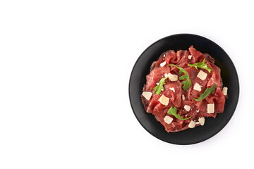 Marbled beef carpaccio on black plate isolated on white background. Top view. Copy space