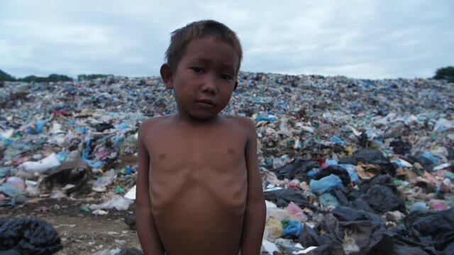 Poverty Boy With Garbage Dump
