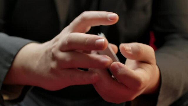 Closeup of hands shuffling a deck of cards.