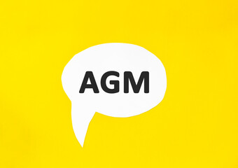 Text AGM speech bubble isolated on the yellow background. Business concept. Annual general meeting