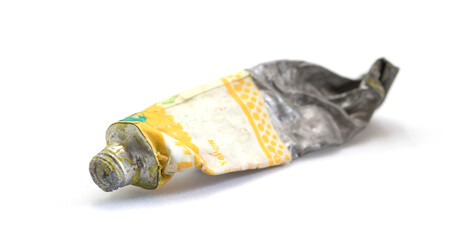 Close-up Old tube of artist oil paint with yellow colors on white background