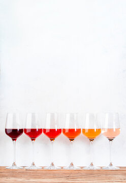 Rose Wine Glasses Set On Wine Tasting. Different Varieties, Colors And Shades Of Pink Wines On White Background