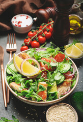 Salad with grilled chicken, tomatoes, arugula, red onion, avocado, sesame seeds and lemon oil dressing. Healthy food. Top view