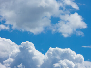Blue sky with layer of fluffy cumulus clouds