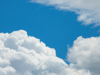 Naklejka na ściany i meble White fluffy cumulus clouds on a blue sky