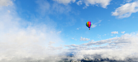 Hot air balloon flying above clouds