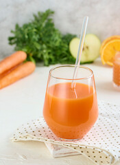 Glass of carrot juice smoothie in lifestyle scene. Copy concept.