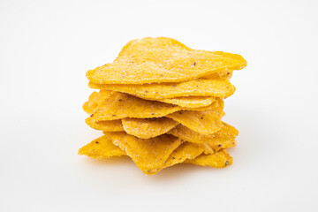 tower of Nachos on a white table. Mexican snack, corn tortilla chips.