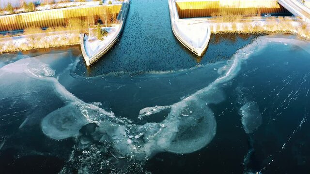 Veluwemeer Aqueduct in Harderwijk, Netherlands, aerial drone flying above frozen lake, dolly in