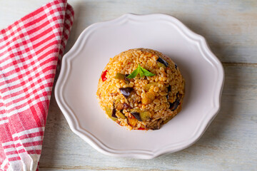 Traditional delicious Turkish food; Bulgur pilaf with eggplant and vegetables. (Turkish name;...