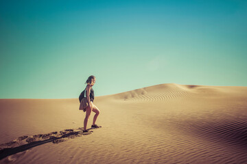 Fototapeta na wymiar young girl walking on the beach sand dunes