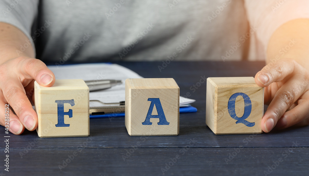 Poster man sits at a table and holds cubes. inscription faq (frequently asked questions) on wooden blocks o