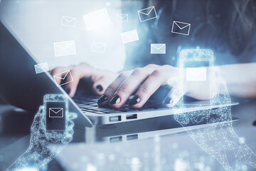 Double exposure of woman hands typing on computer and flying envelop drawing. E-Mail concept.