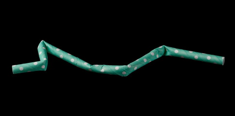 Crumpled eco friendly paper drinking straw isolated on black background with clipping path
