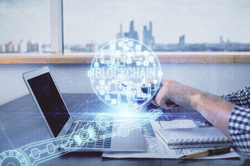 Double exposure of man's hands holding and using a phone and crypto currency blockchain theme drawing.