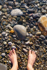summer vacation at the sea, sunbathing vacation. leg man. vertical photo