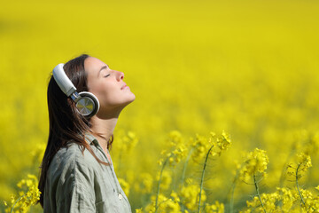 Woman meditating listening audio guide on headphones