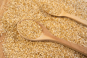 quinoa texture with wooden spoons. quinoa background. quinoa seed. top view