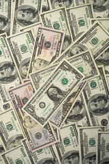 A money pile of various US banknotes with president Washington portrait on top. Cash of dollar bills, paper currency background.