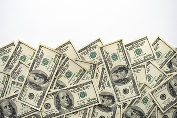 A money pile of one hundred US banknotes with president Franklin portrait on white background. Cash...