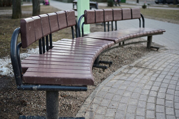 Fototapeta na wymiar Photo of a street bench for rest in the city in spring