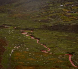Papier Peint photo autocollant Vinicunca Red sandstone mineral sediment coloured river stream in green grass valley at Vinicunca Rainbow Mountain in Cusco Peru
