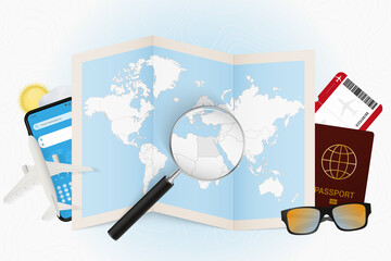 Travel destination Egypt, tourism mockup with travel equipment and world map with magnifying glass on a Egypt.