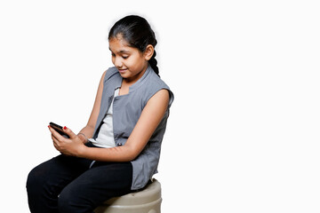 indian Female child using smart phone on white background