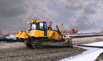 yellow bulldozer is carrying out road construction works