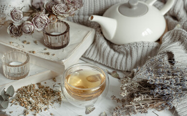 Cozy home composition with herbal tea and decorative elements.