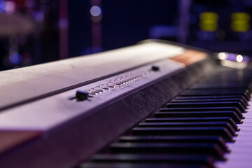 Close-up of piano keys in a dark room.