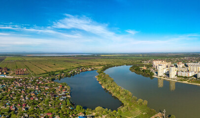 Fototapeta na wymiar Lake Brzhegokai near the Kuban river not far from the city of Krasnodar in southern Russia with a sunny May morning - aerial view
