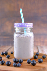 blue berry milk shake in a glass on table 