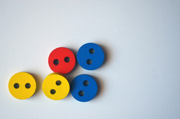 Multi-colored buttons on a white background.