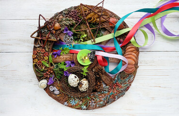 Wiccan altar for Beltane sabbath. spring pagan festive ritual. wheel of the year with ribbons,...