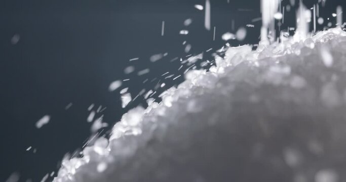 White salt granules falling into a pile. Bath cosmetic salt particles chaotically dropping - macro close up shot 4k footage