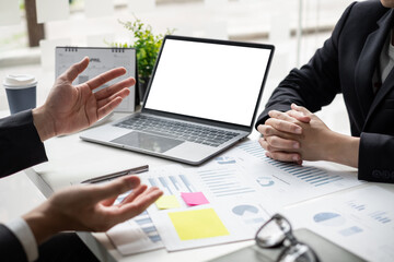 Two businessmen are discussing about earnings on a graph to plan investments.