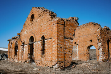 Abandoned brick building. Sunny day, blue sky. A brick ruined house.