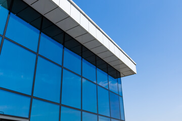Fototapeta na wymiar Building of the glass skyscraper with a blue flare against the sun against a blue sky. High quality photo