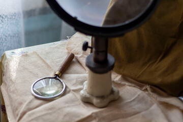 Group of old vintage retro loupes magnifier on canvas top view, searching concept