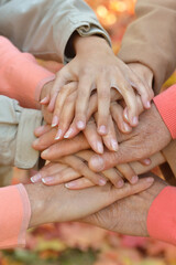cropped image, family putting  hands together