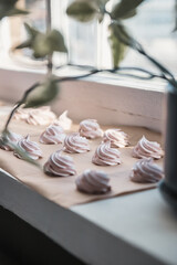 Homemade marshmallow on parchment paper dries in the sun on a windowsill. Homemade sweets, comfort, handmade