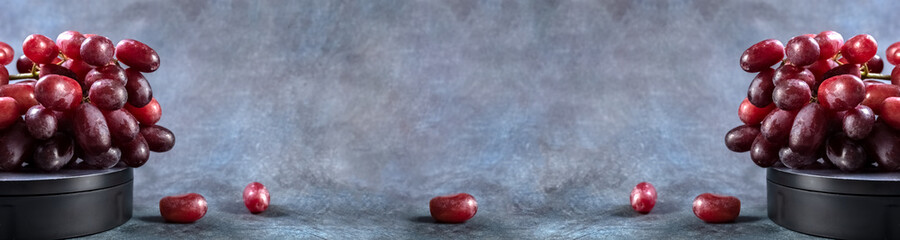 Red grapes on a blue vintage background. Banner. Copy space. High quality photo