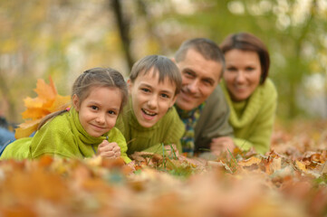 Fototapeta premium Portrait of happy young family in autumn park