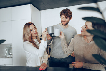 Young businesspeople colleagues having a coffee break in office, drinking and talking
