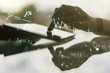 Double exposure of creative scientific formula concept with finger clicks on a digital tablet on...