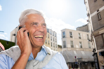 man smiling and talking with mobile my-one in city