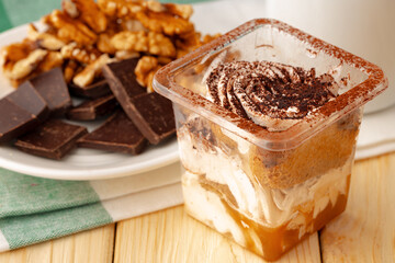 Mousse dessert with chocolate on wooden background
