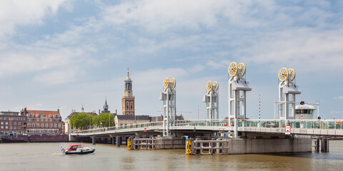 Summer view of the river IJssel with entrance bridge of the Hanseatic historic city of Kampen, The...